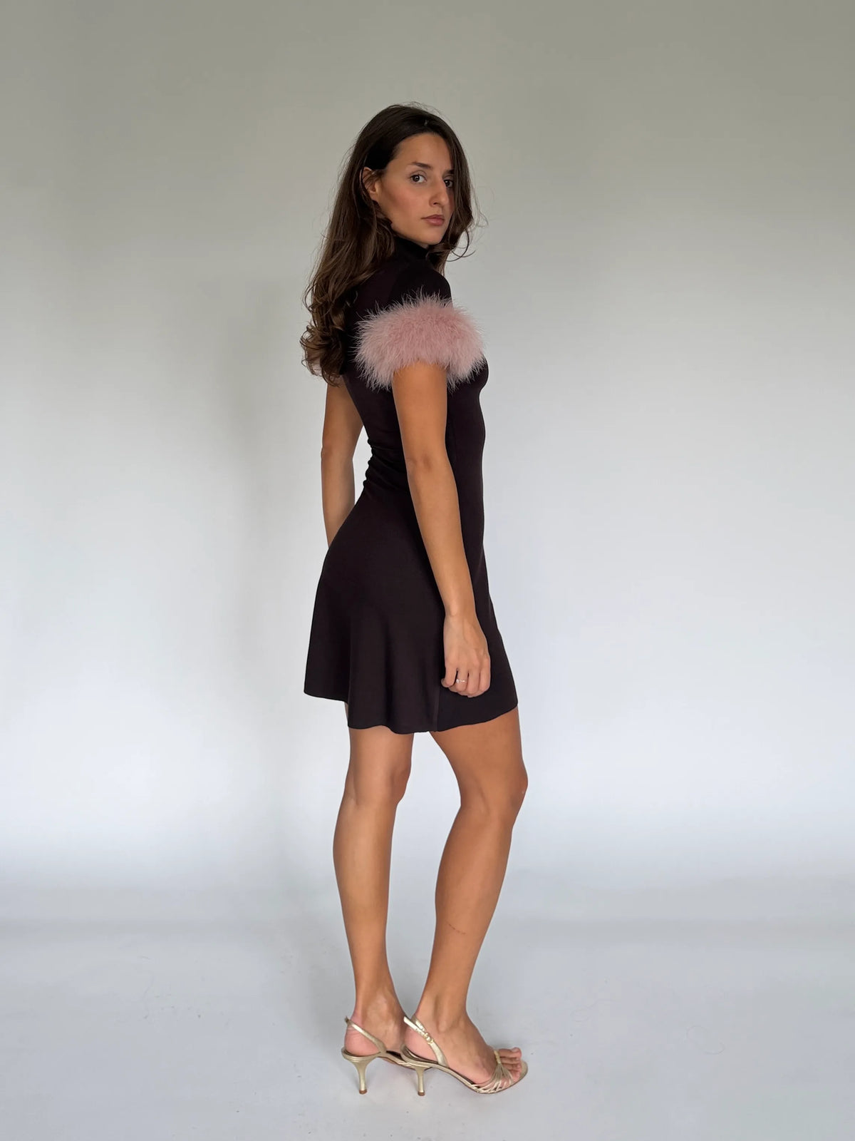 Back view of the NOA chocolate mini dress, high neck and pale pink marabou cuffs